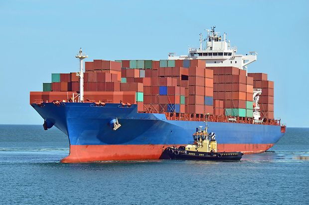 Ein Containerschiff wird auf das offene Meer gebracht.