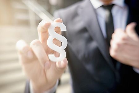 businessman holding paragraph symbol - law concept image