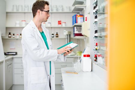 Male pharmacist working at the chemist store