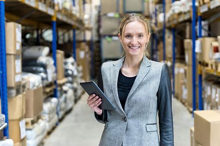 Female businesswoman checking the stocks and using tablet