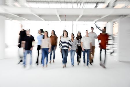 Group of enthusiastic business people walking