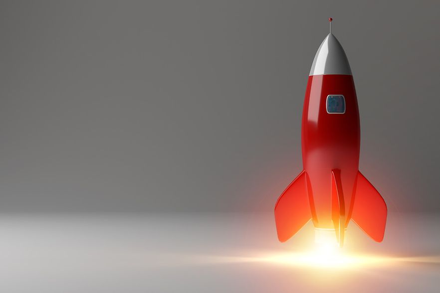 Rakete startet vor einem grauen Hintergrund 
