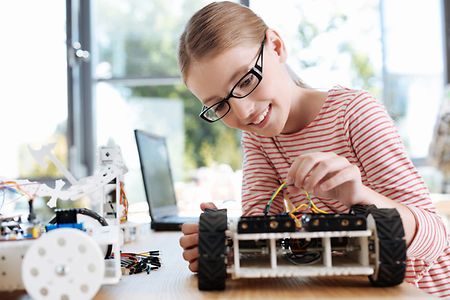 Smiling girl checking intactness of wires