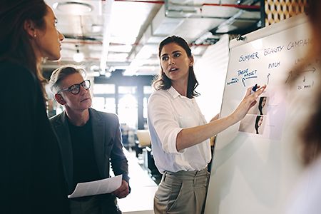 Woman giving presentation over new advertising in office
