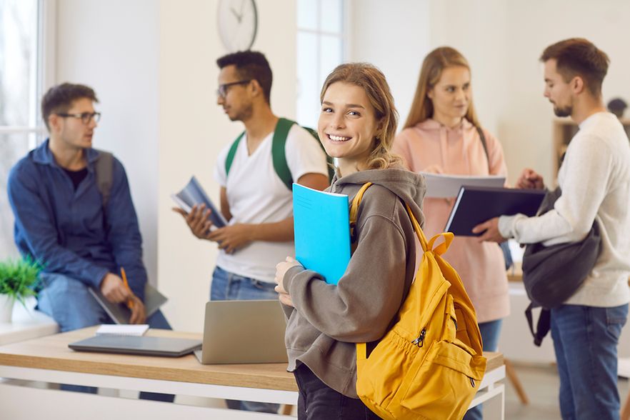 Portrait of smiling girl student with backpack