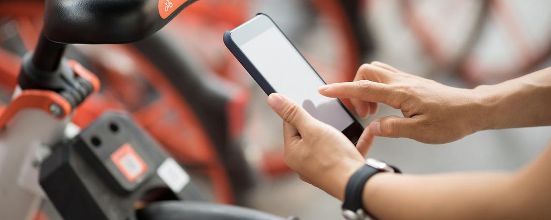 Jemand scannt einen QR-Code zum Bikesharing ein.