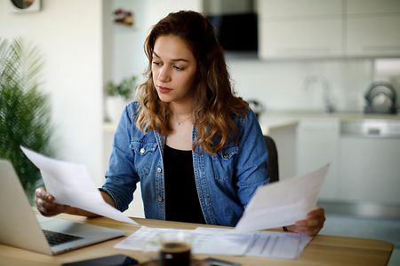 Serious young woman working at home