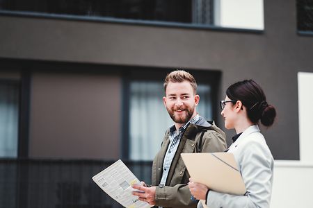 Real estate agent and customer looking for apartment