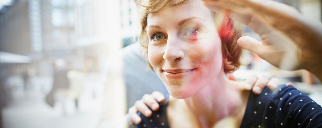 Smiling couple behind window