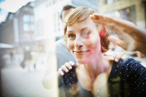 Smiling couple behind window