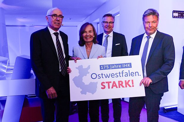 Vier Personen stehen nebeneinander und halten ein Schild mit der Aufschrift &bdquo;175 Jahre IHK &ndash; Ostwestfalen. STARK!&ldquo; 