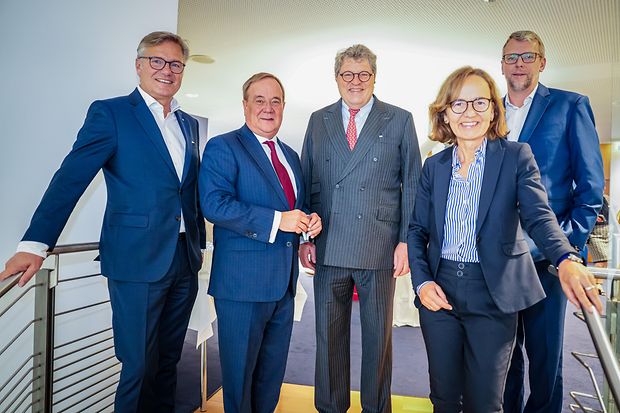 F&uuml;nf Personen, darunter Armin Laschet, bei einem Gruppenfoto in Business-Kleidung.