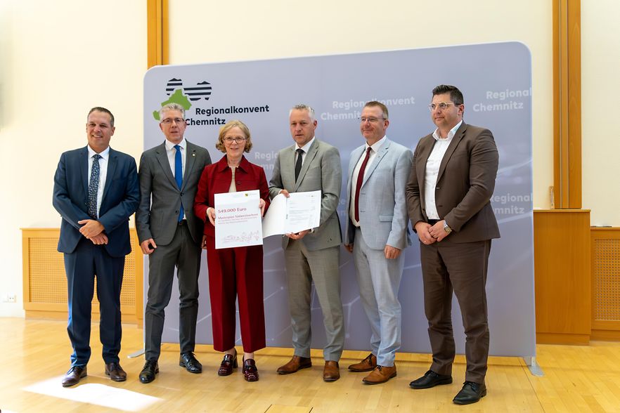 F&uuml;nf M&auml;nner und eine Frau pr&auml;sentieren Dokumente