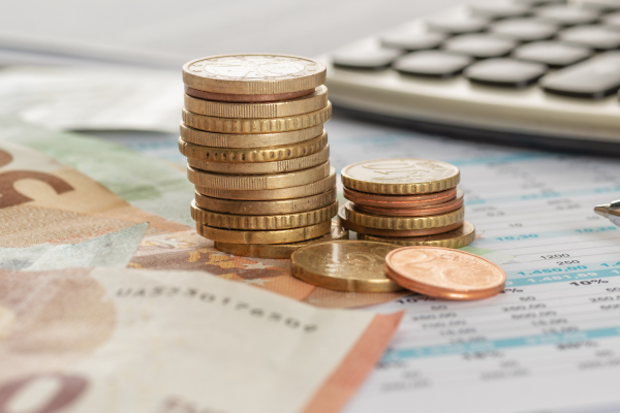 Geld mit Taschenrechner und Kugelschreiber