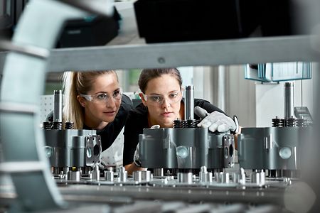 Young women checking production line on a conveyor belt