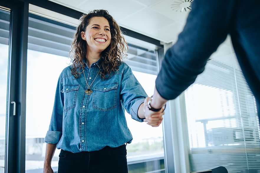 Recruitment manager shaking hand with male candidate