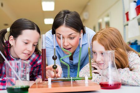 Children and teacher with chemistry experiments