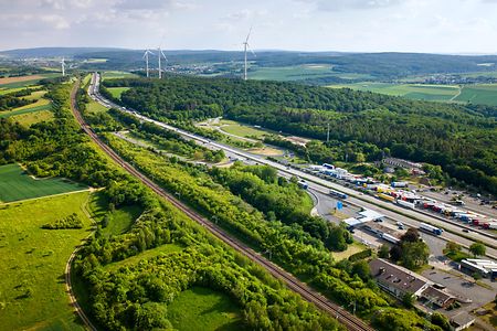 German highway and highspeed train railroad track - aerial view